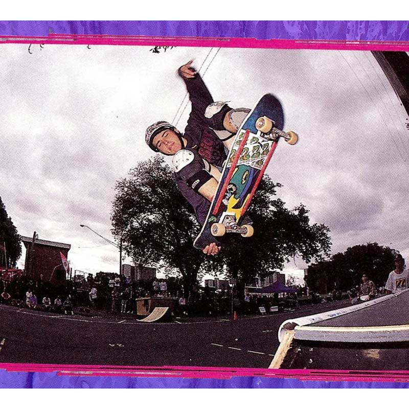 Dean Sammut performing an Ollie Tail grab to Fakie on a Quarter Pipe.
  Dean is wearing a helmet and knee pads.